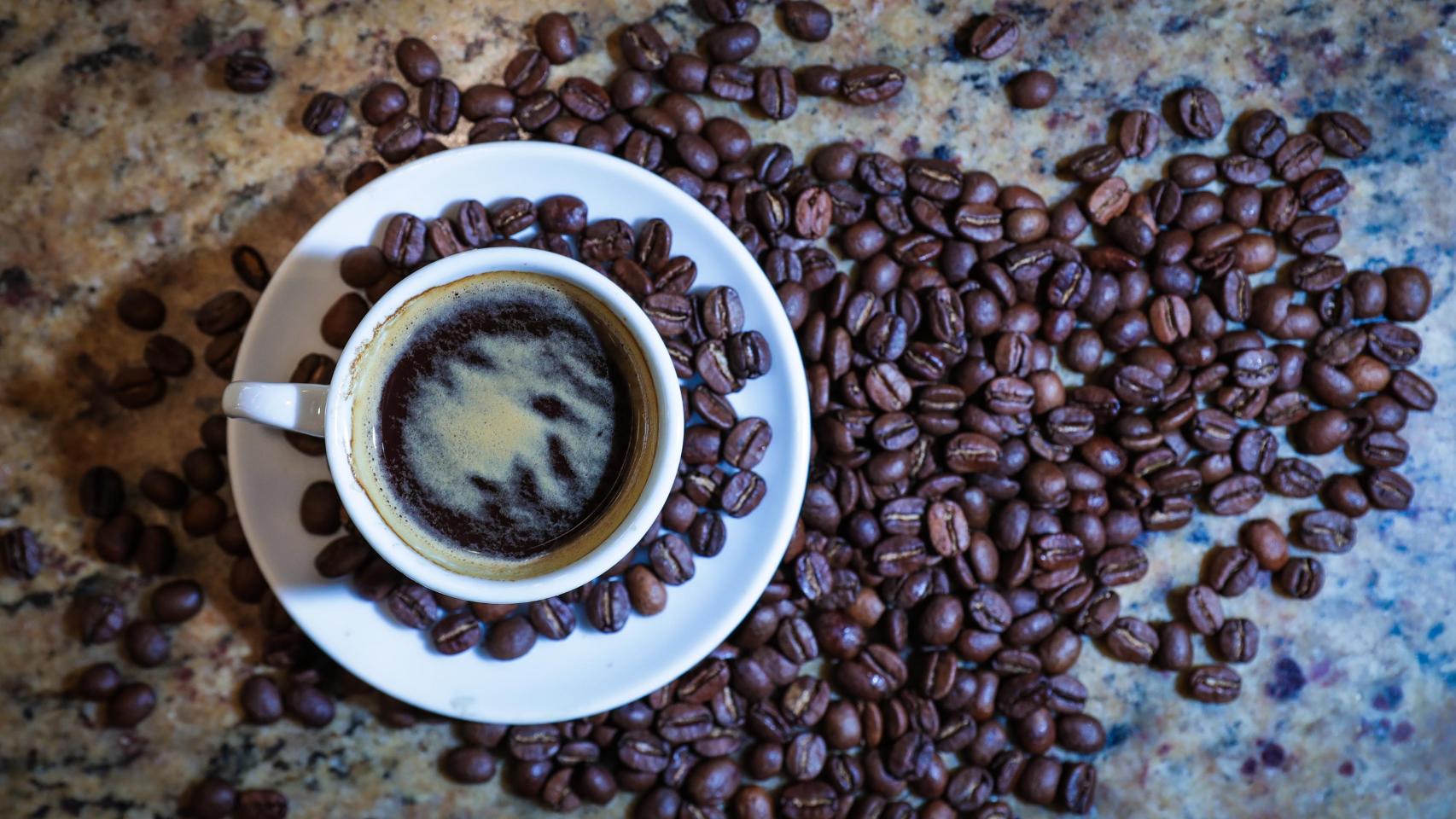 Una taza y granos de café.