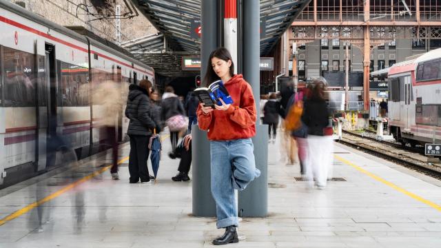 Una joven lee en una estación de tren. Foto: Rodrigo Mínguez