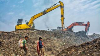 Dos niños rebuscando basura en un vertedero.