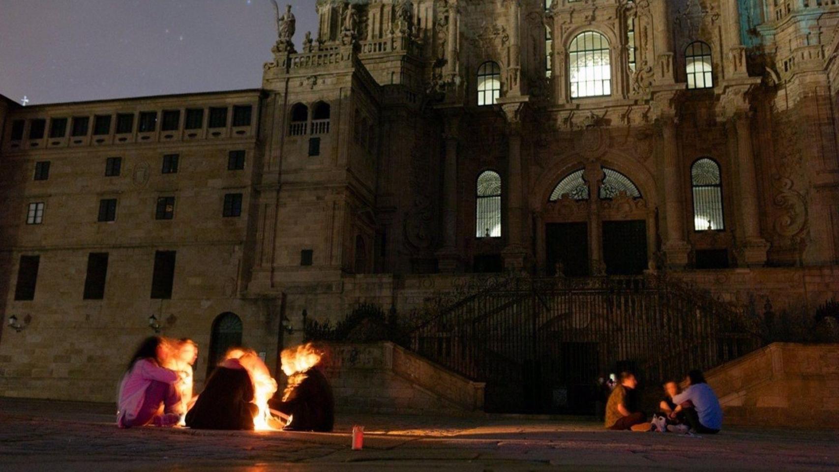 Gente a la luz de velas en la praza do Obradoiro, este lunes.
