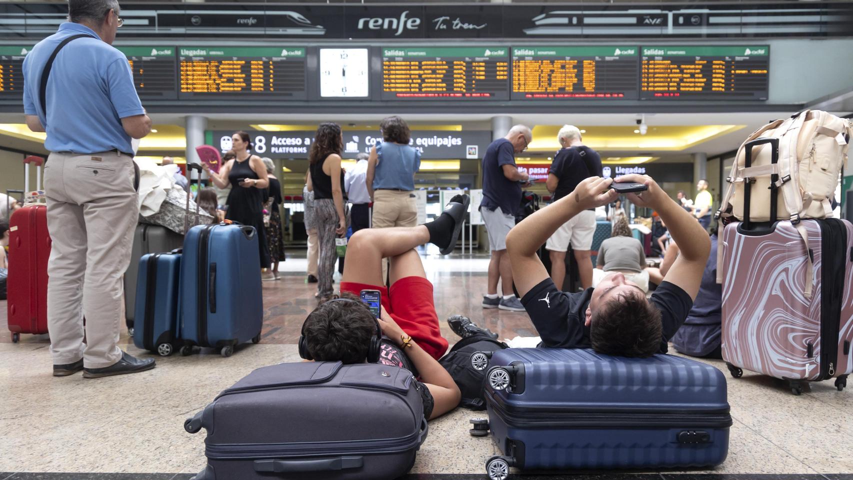 Numerosas personas aguardan en la estación de trenes ante los retrasos.