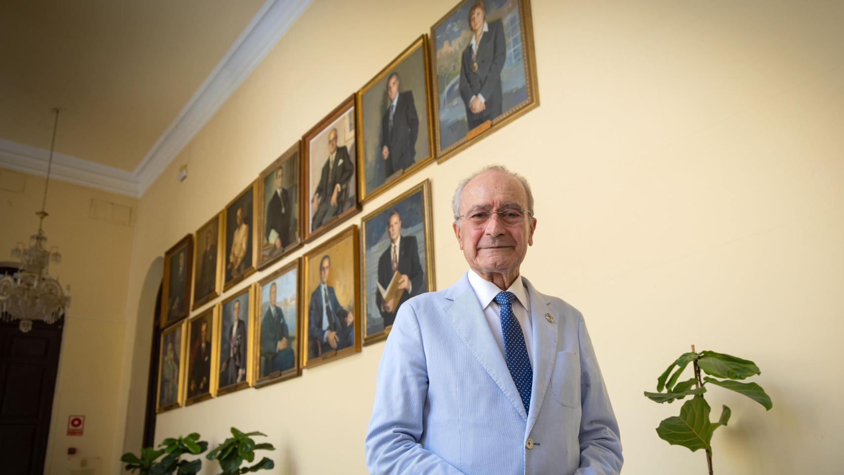 Francisco de la Torre posa junto a la pared donde se encuentran colgados los cuadros de los anteriores alcaldes de Málaga.