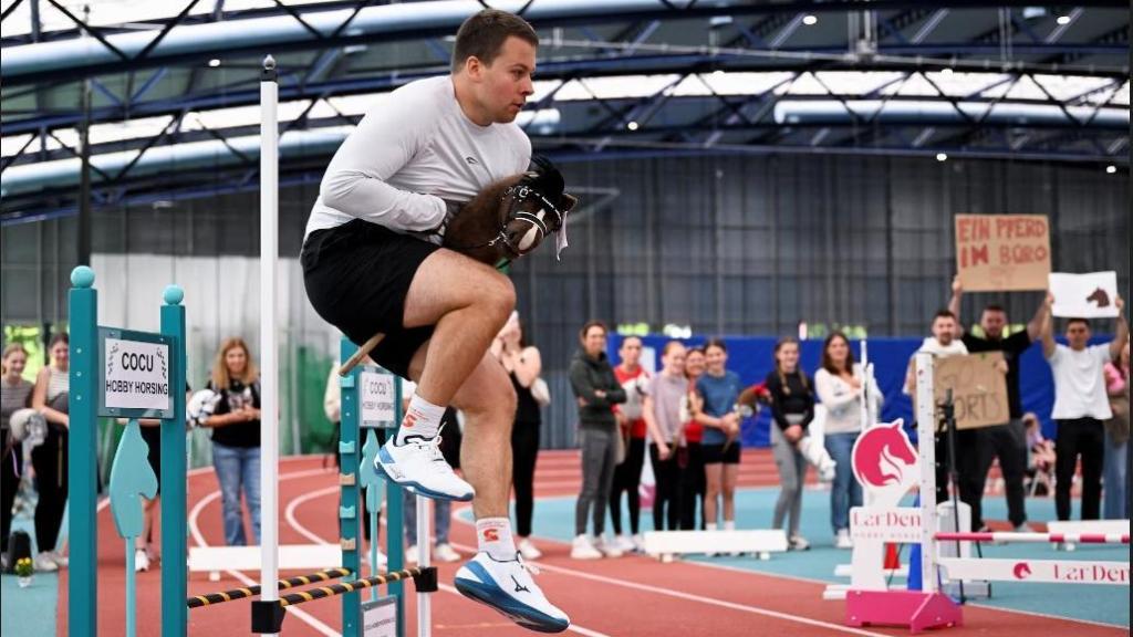Daniel Alsdorf, de 29 años, mientras participa con su caballo de juguete el día del primer Campeonato Alemán de Caballos de Juguete en Frankfurt, Alemania.