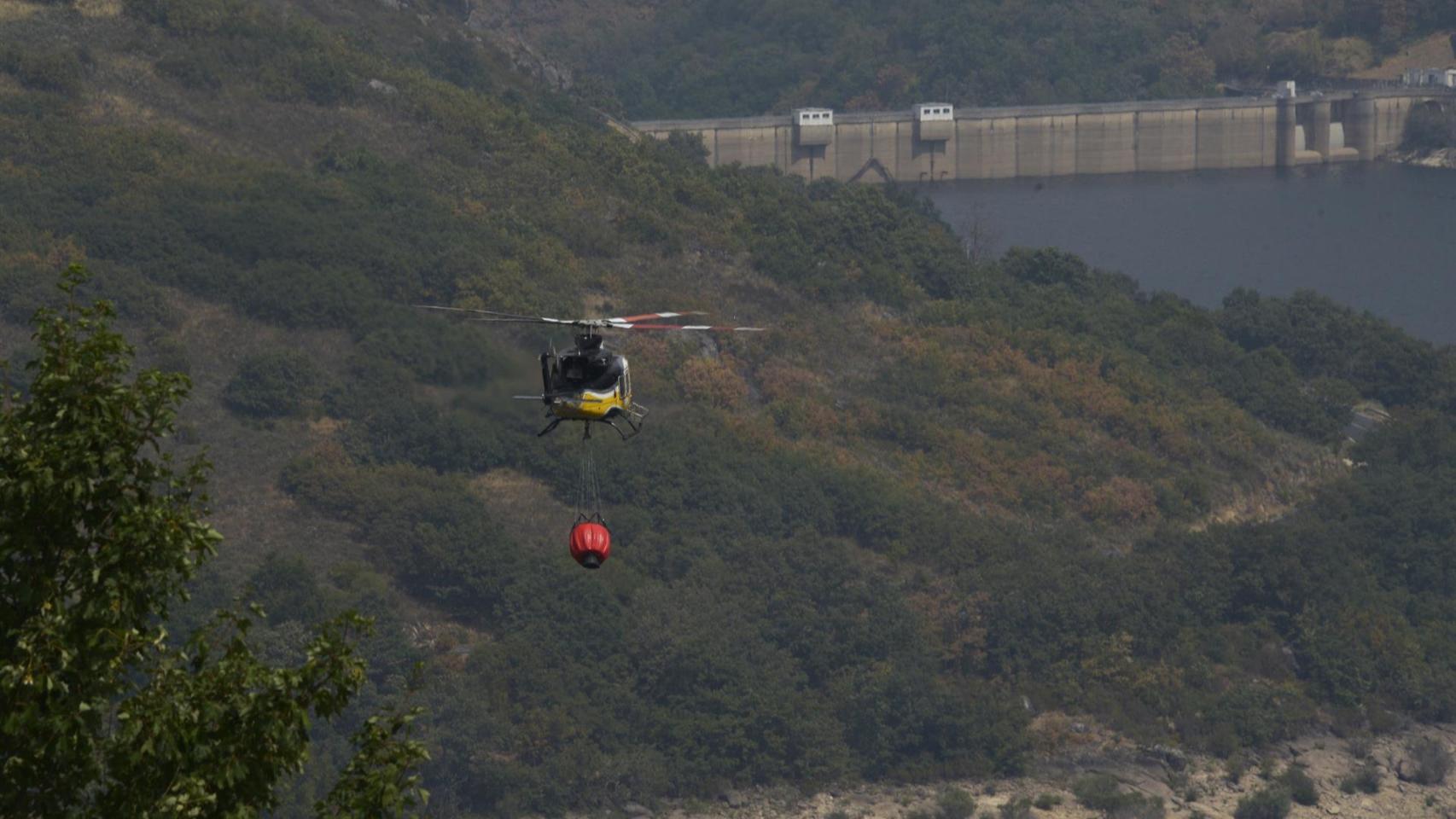 Un helicóptero de extinción recoge agua en el embalse de Chandrexa de Queixa.