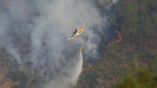 Helicóptero bombardero trabaja para extinguir el fuego