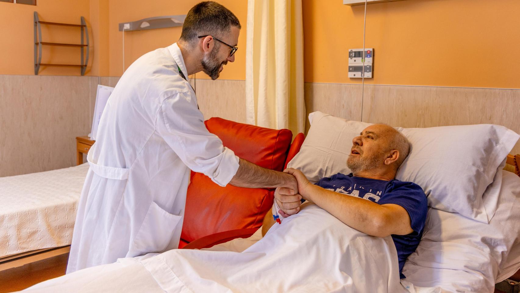 Médico de Cudeca junto a un paciente.