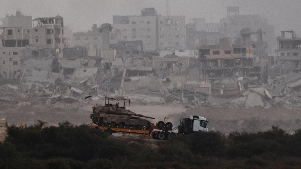 A truck transports a tank, on the Israeli side of the Gaza Strip.