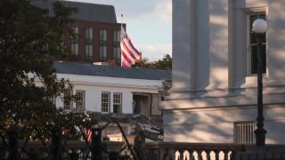 A bulldozer demolishes part of the East Wing of the White House.
